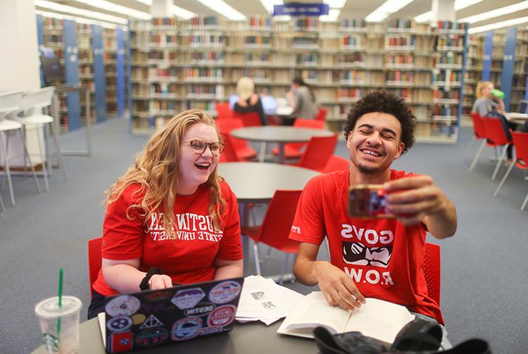 Students pose for photo in library